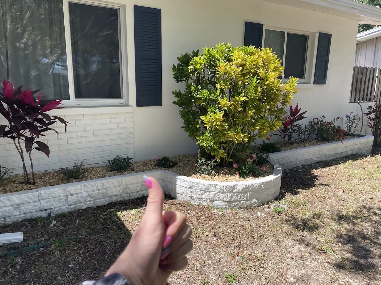 Foundation planting bed with a low white block border